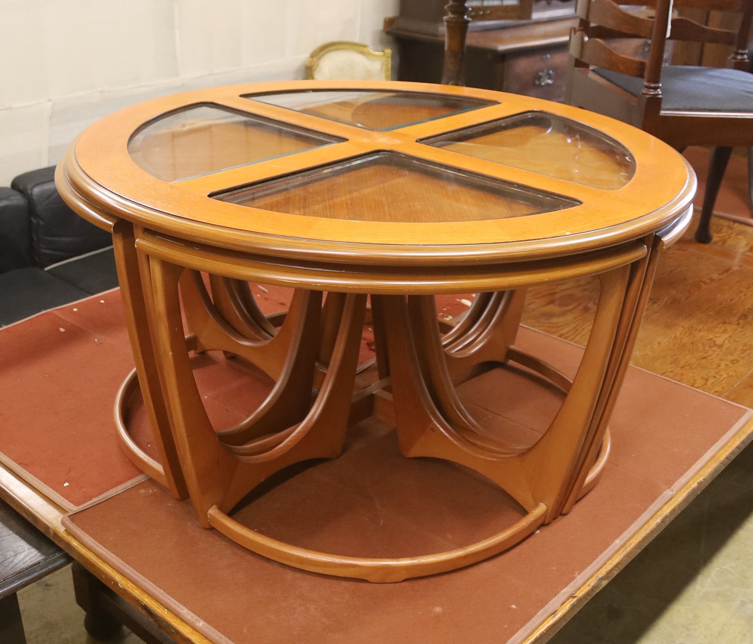 A nest of G plan teak tables, diameter 88cm, height 48cm